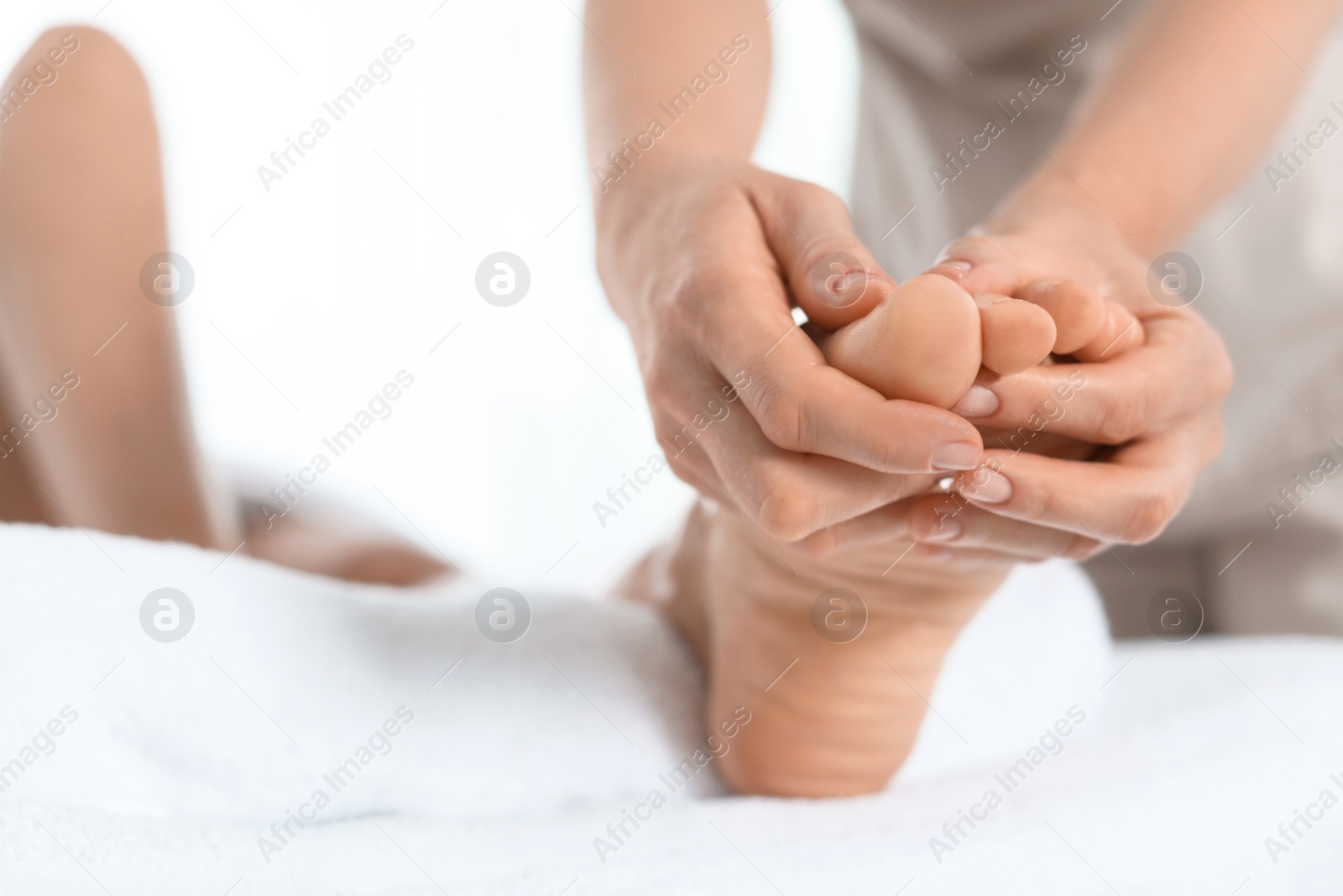 Photo of Woman receiving foot massage in wellness center, closeup