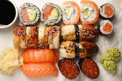 Photo of Set of delicious sushi rolls on board, top view