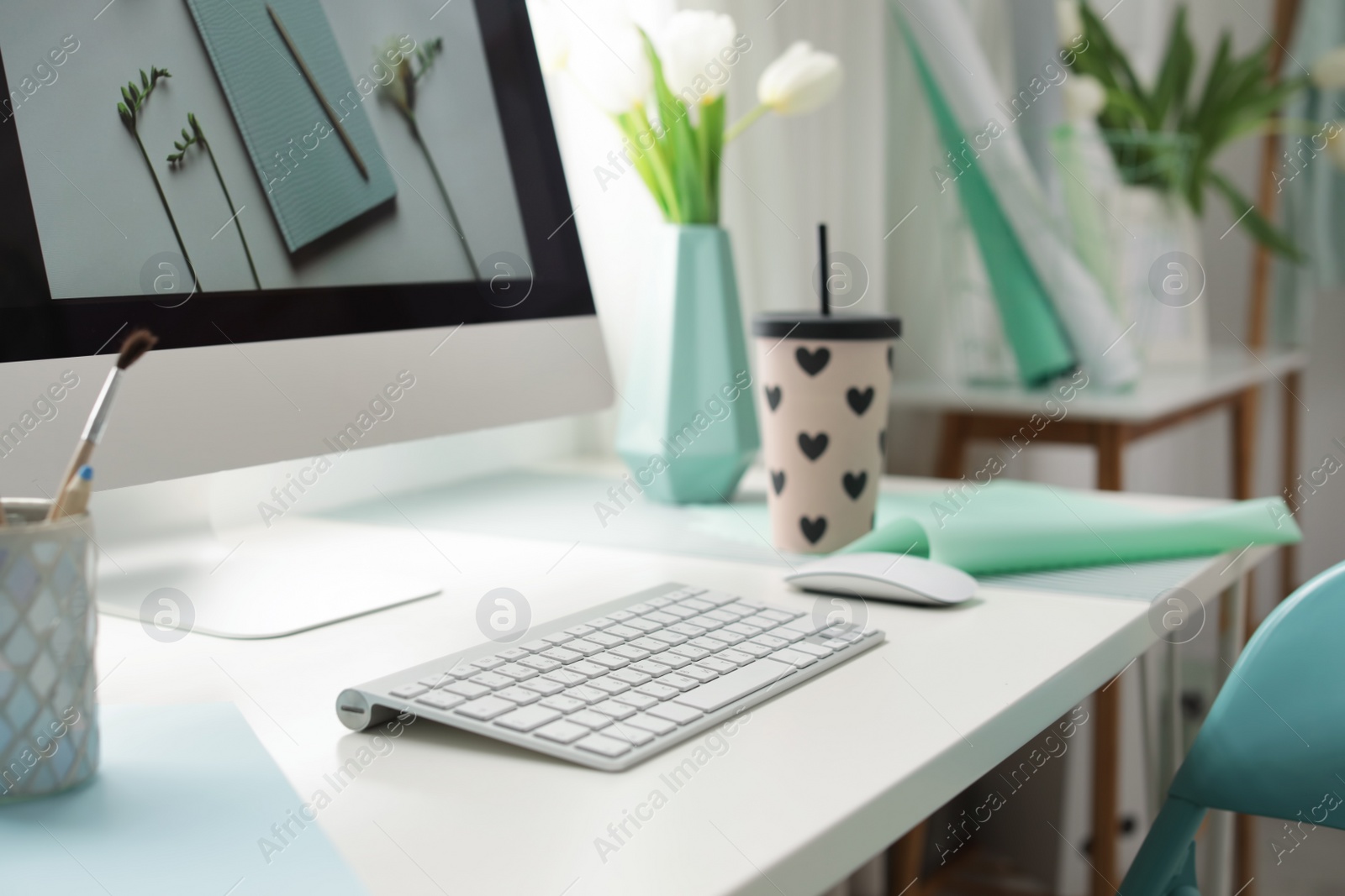 Photo of Stylish workplace with modern computer on desk. Focus on keyboard