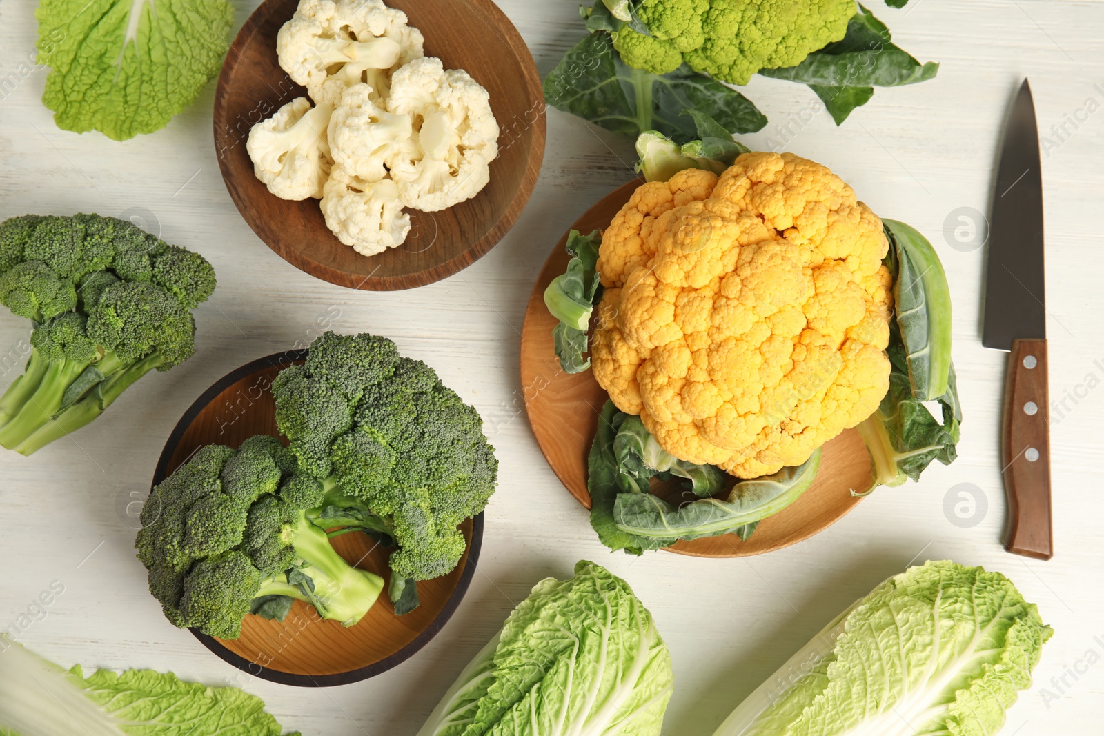 Photo of Different fresh cabbages on table, top view. Healthy food