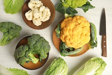 Photo of Different fresh cabbages on table, top view. Healthy food