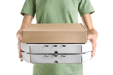 Woman holding cardboard pizza boxes on white background