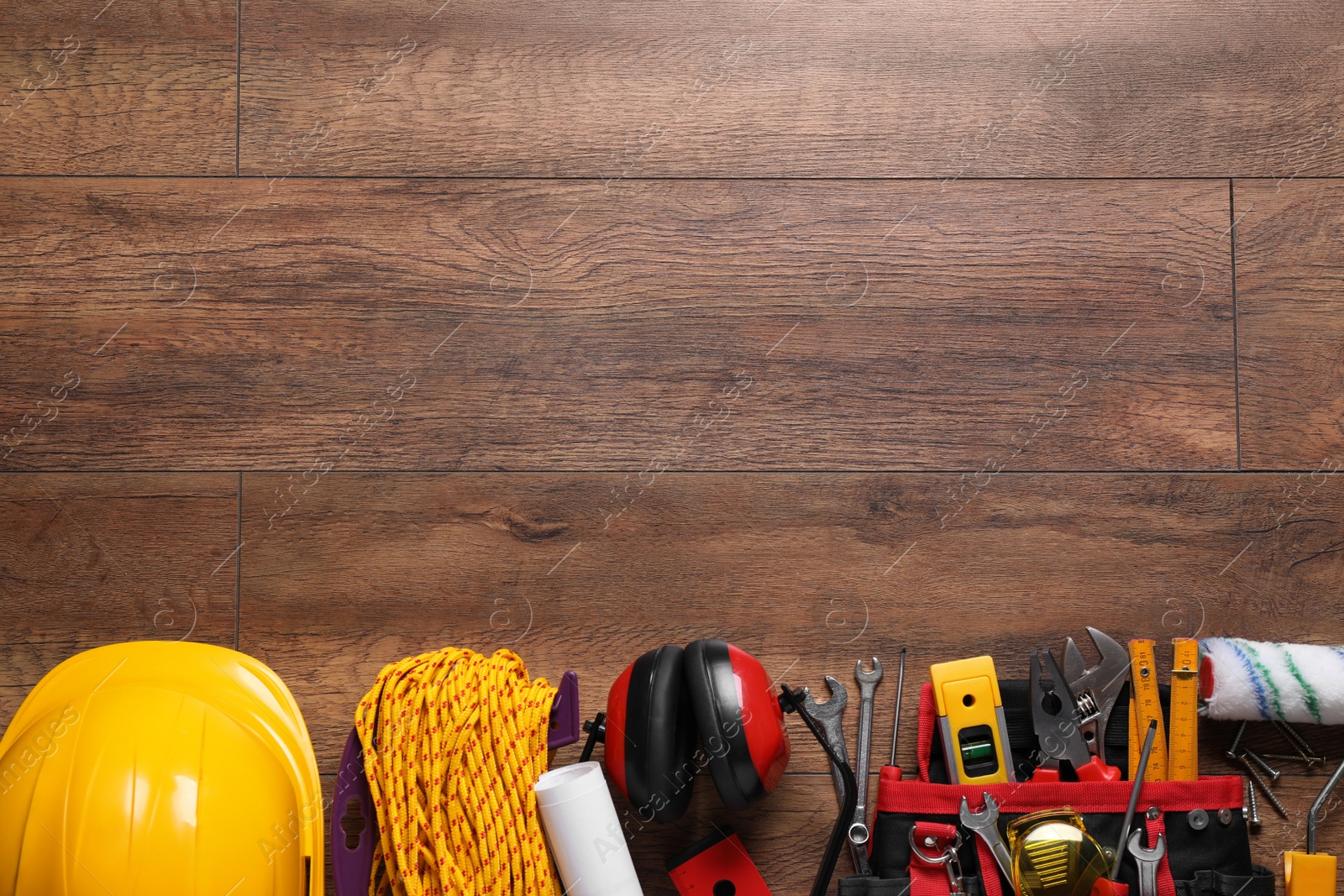 Photo of Flat lay composition with different construction tools and space for text on wooden background