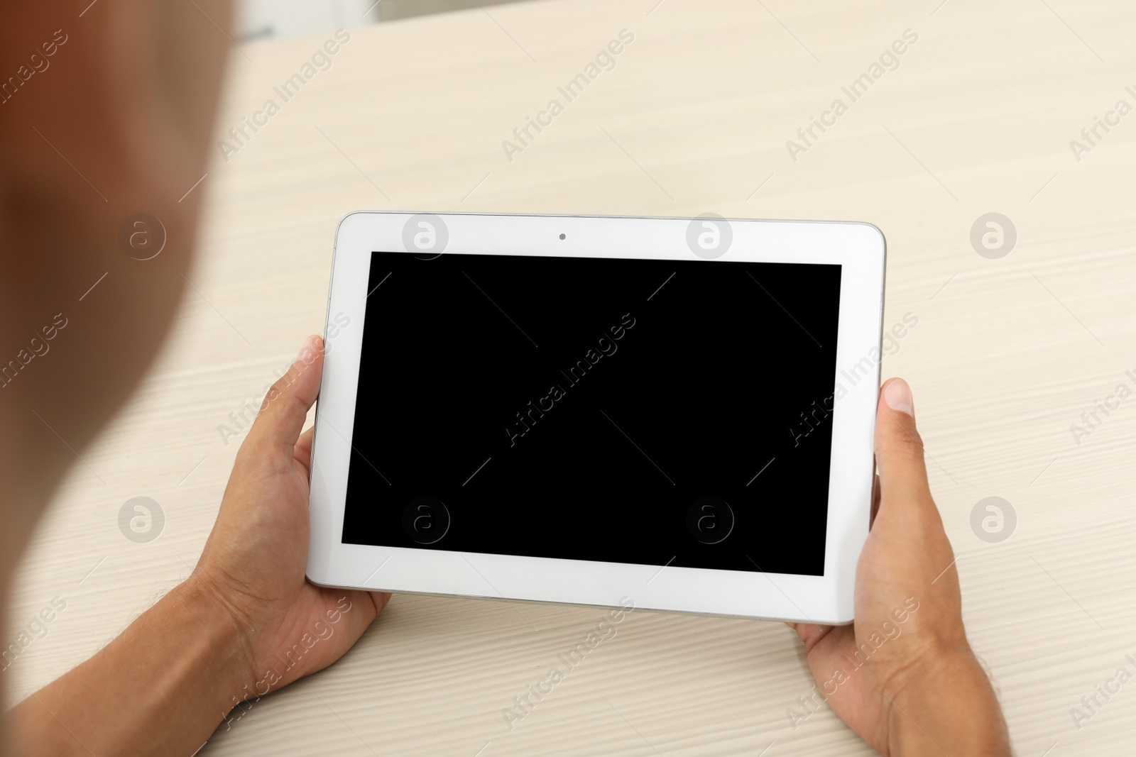 Photo of Man with modern tablet at table, closeup