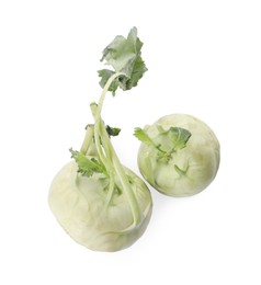 Whole ripe kohlrabies with leaves on white background, top view