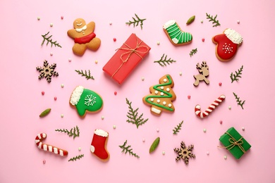 Flat lay composition with Christmas decorations on pink background