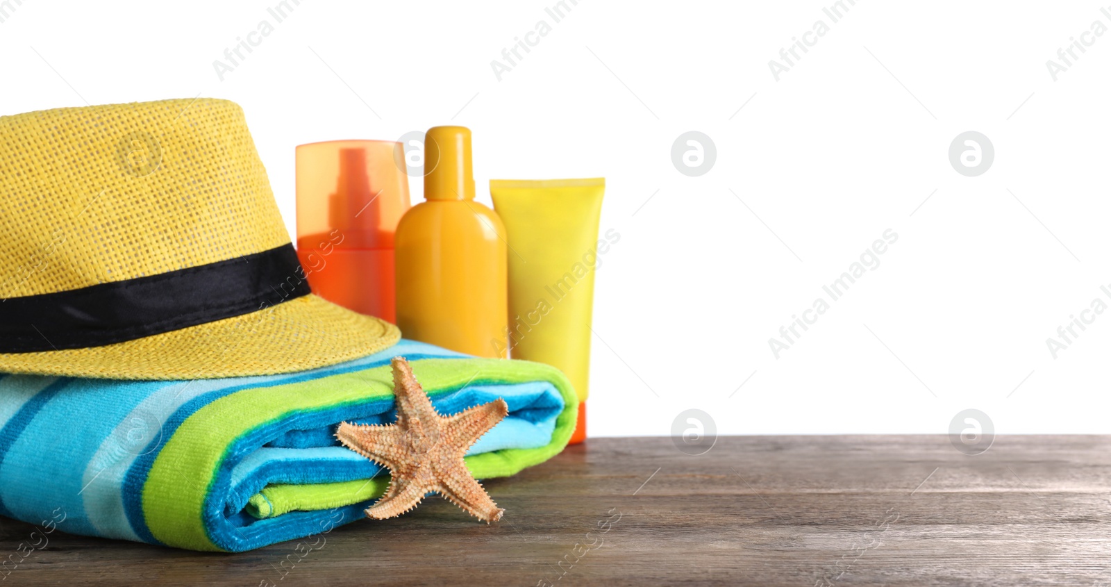 Photo of Different beach objects on wooden table against white background. Space for text