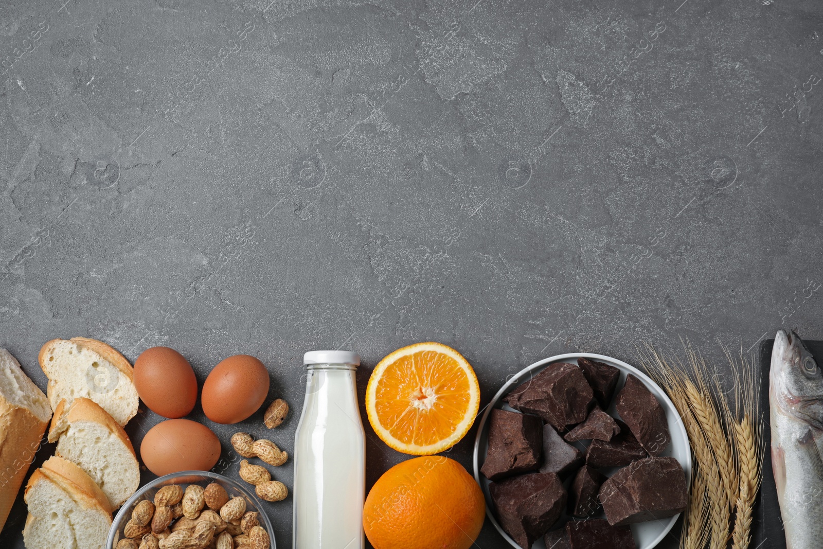 Photo of Flat lay composition of different products and space for text on grey table. Food allergy concept