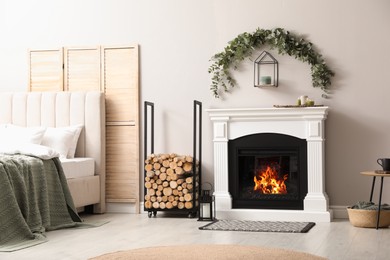 Photo of Stylish room decorated with beautiful eucalyptus garland above fireplace