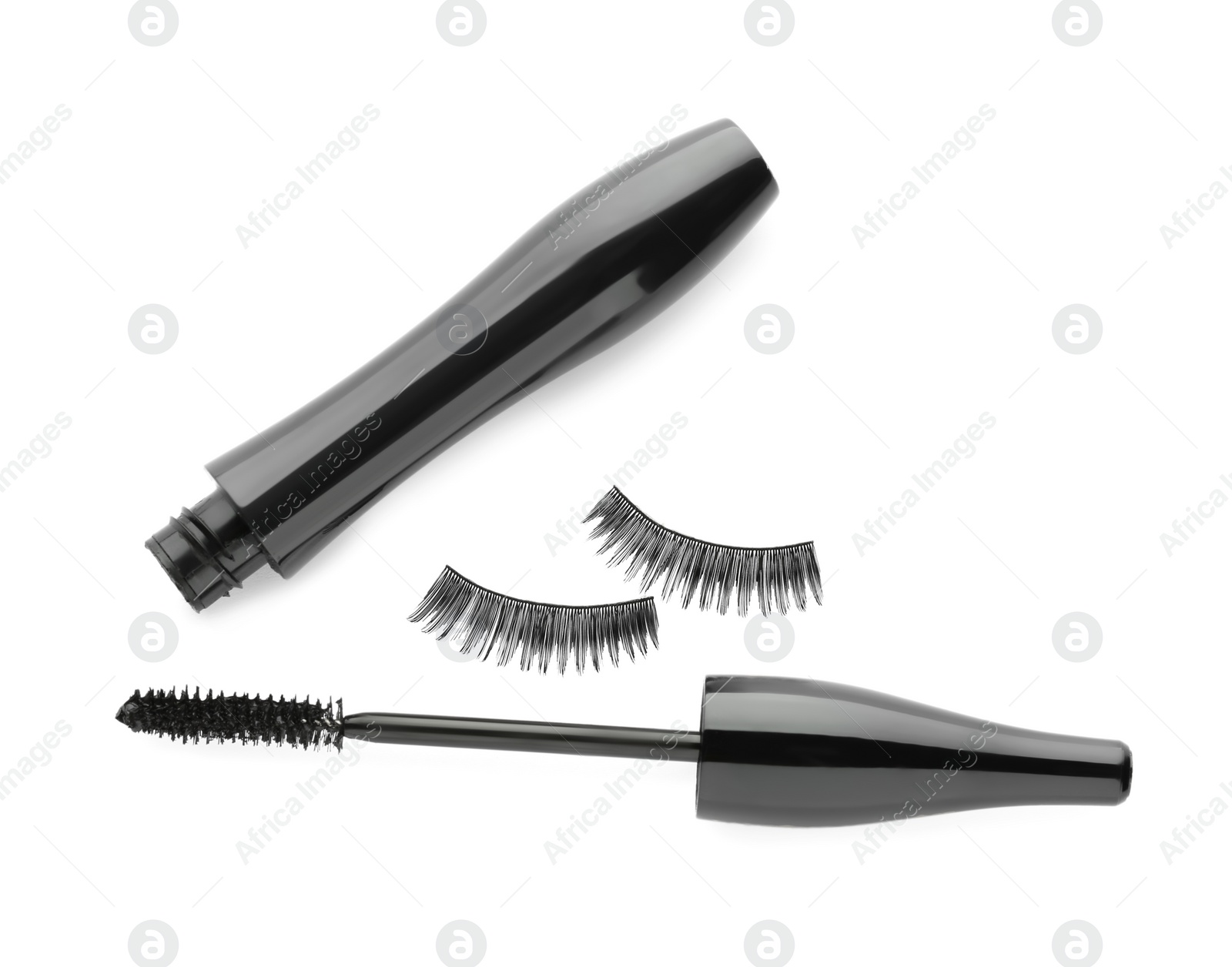 Photo of Black mascara and fake eyelashes on white background, top view