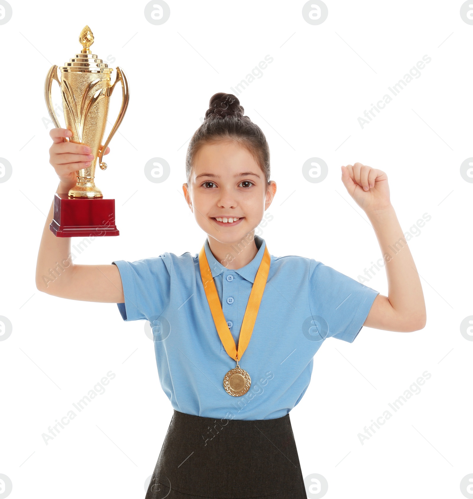 Photo of Happy girl in school uniform with golden winning cup and medal isolated on white