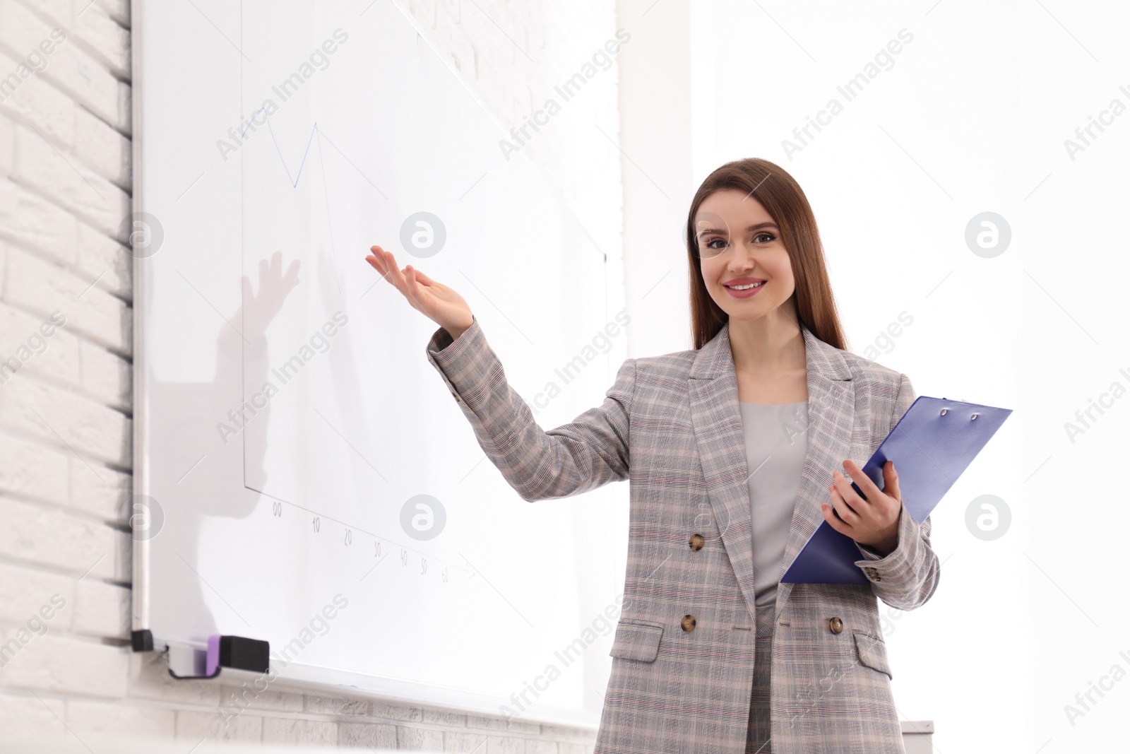 Photo of Professional business trainer near whiteboard in office