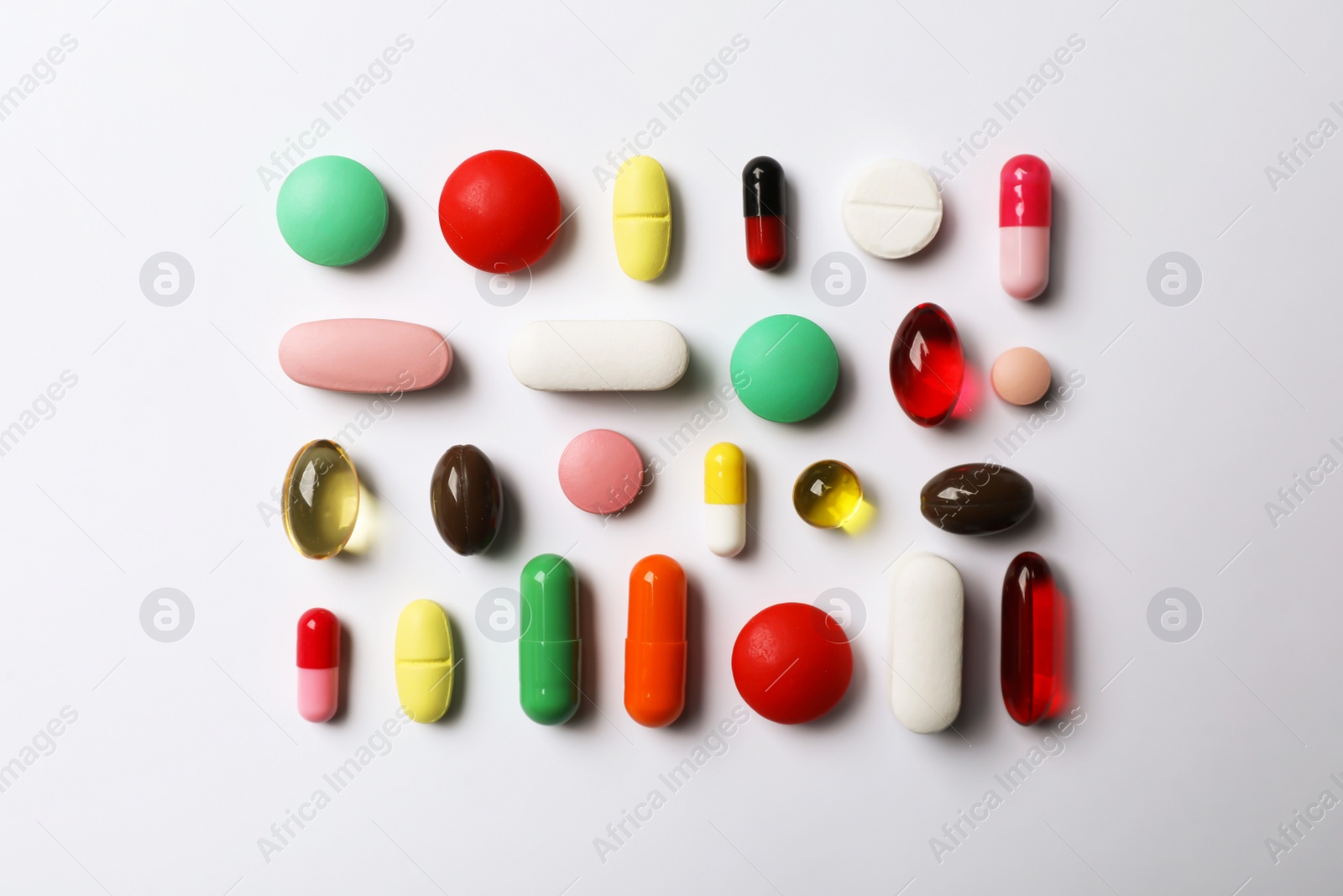 Photo of Flat lay composition with different pills on white background. Medical objects