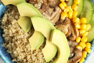 Closeup view of cooked quinoa and garnish