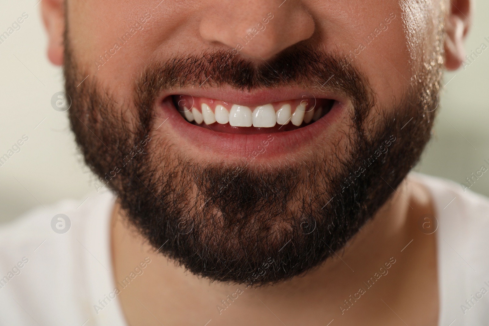 Photo of Happy young man with white teeth, closeup