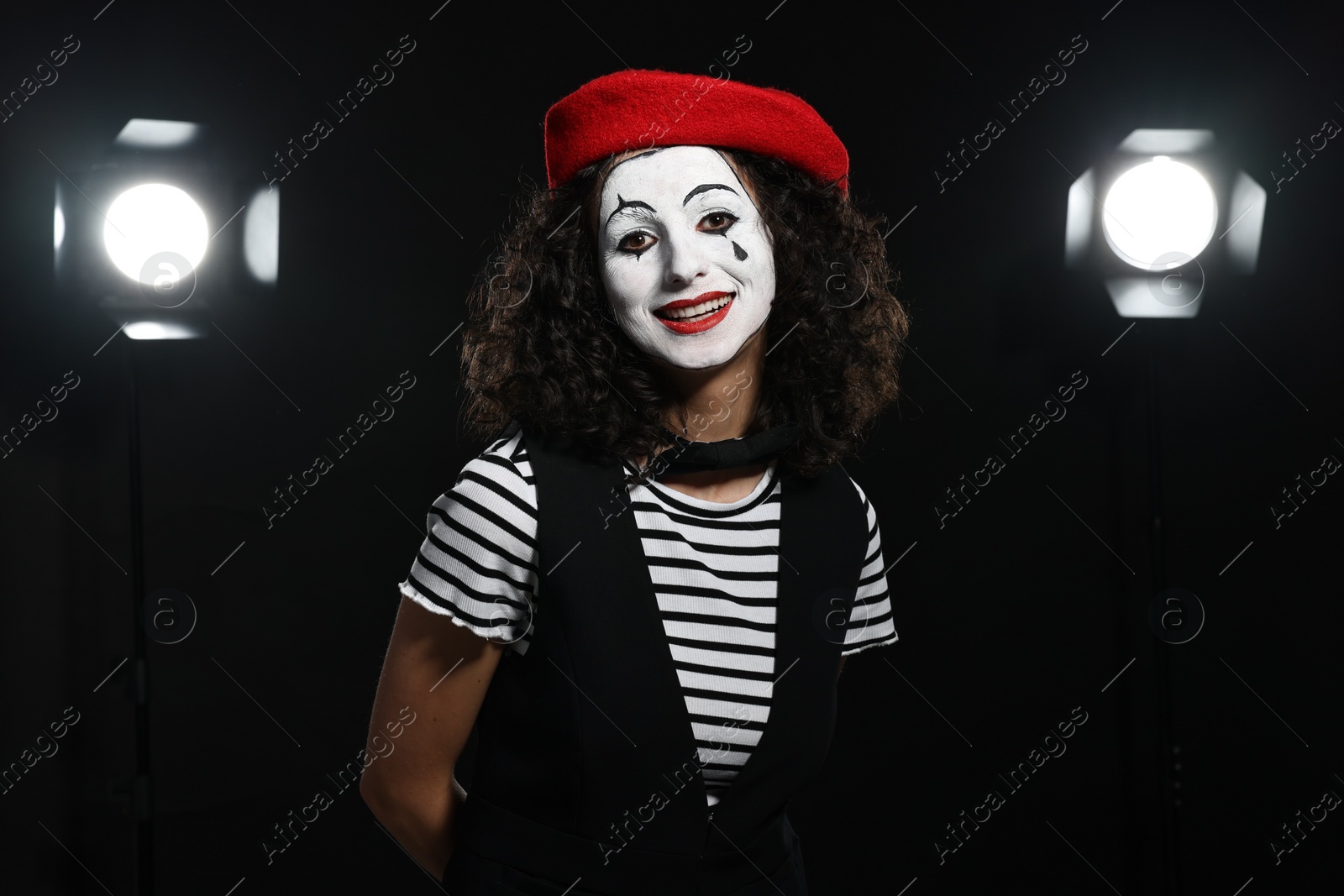 Photo of Young woman in mime costume performing on stage