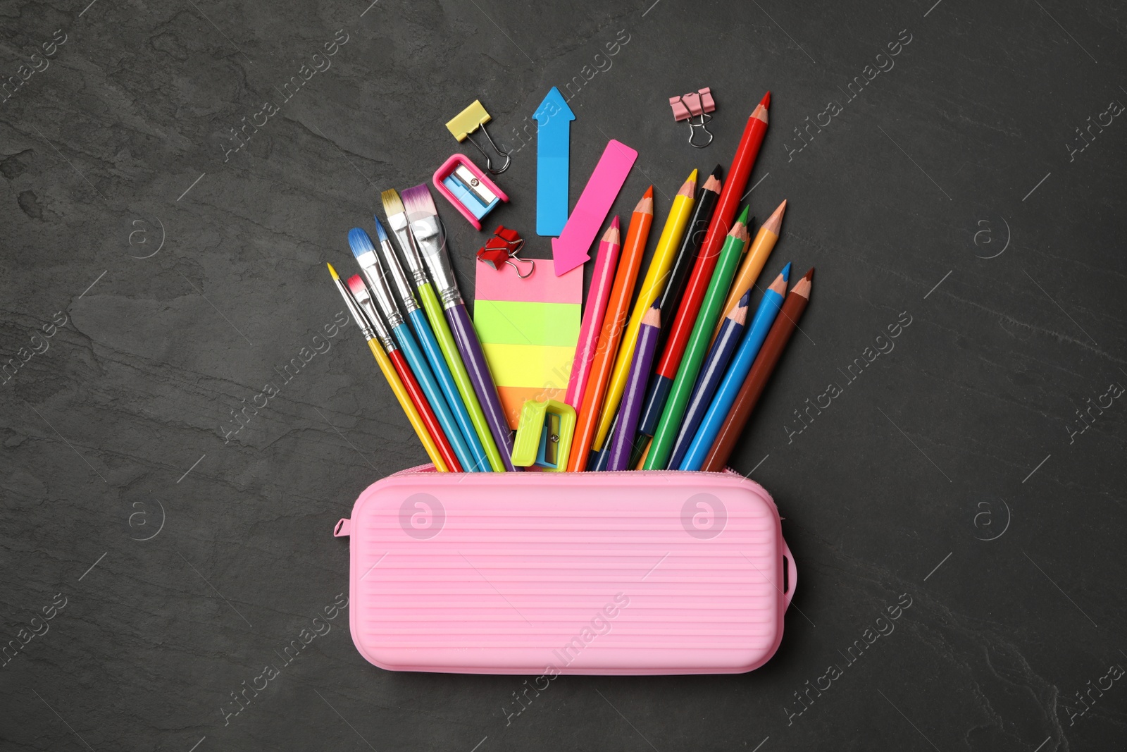 Photo of Flat lay composition with different school stationery on black stone table. Back to school