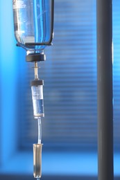 Photo of IV drip against blurred background. Intravenous therapy