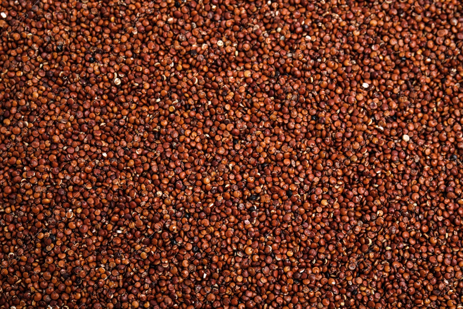 Photo of Heap of red quinoa as background, top view. Veggie seeds
