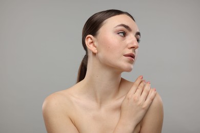 Photo of Portrait of beautiful woman on grey background