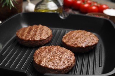 Tasty fried hamburger patties on grill pan, closeup