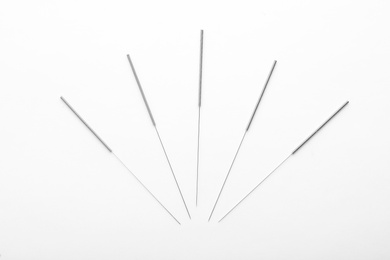 Photo of Needles for acupuncture on white background
