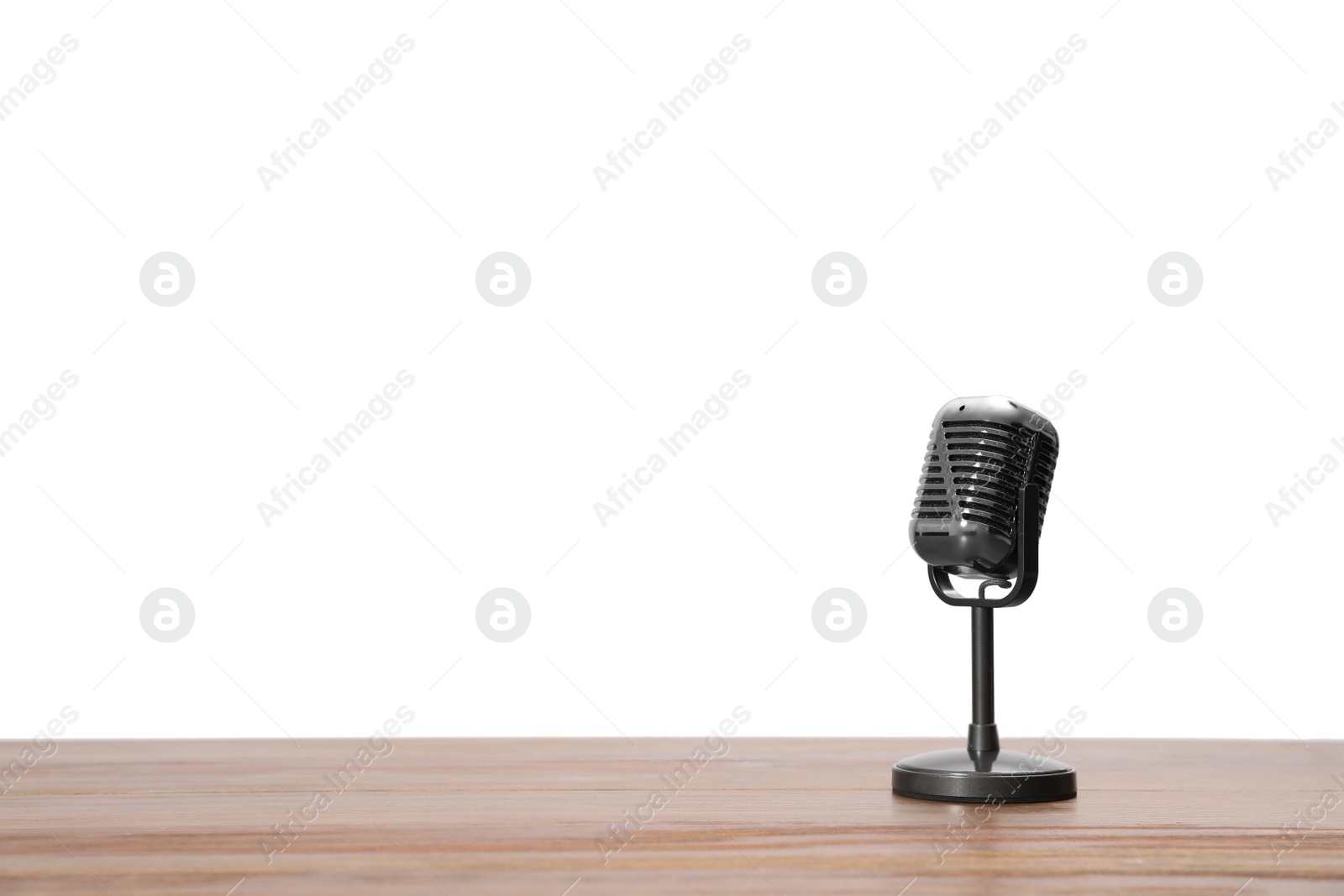 Photo of Vintage microphone on wooden table, space for text. Journalist's equipment