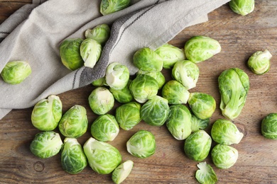 Fresh Brussels sprouts on wooden table, flat lay