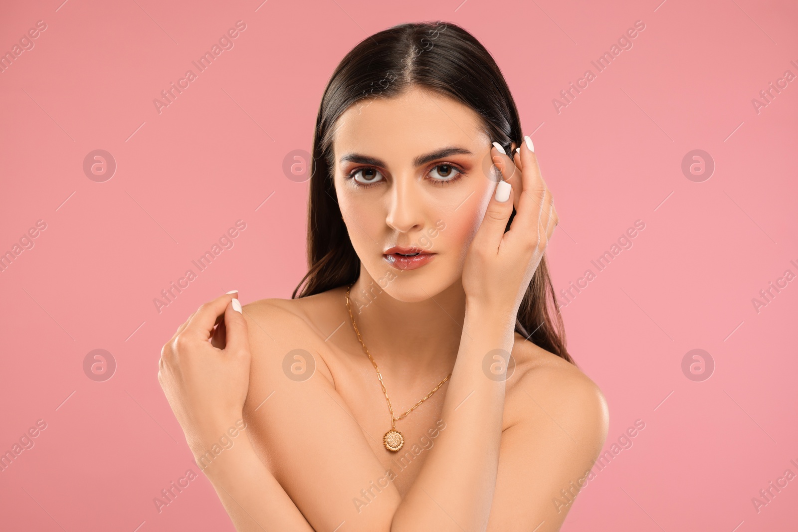 Photo of Beautiful woman with elegant necklace on pink background