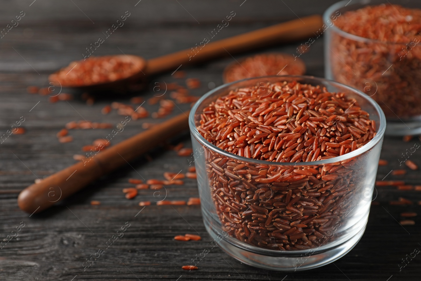 Photo of Brown rice in glass on table. Space for text