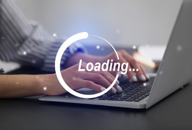 Loading. Woman working on laptop at table indoors, closeup