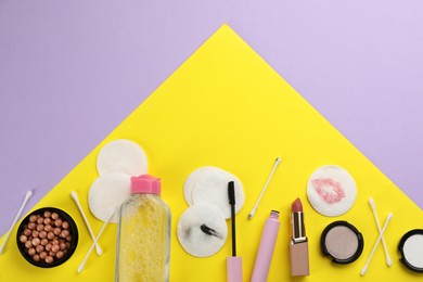 Photo of Dirty cotton pads, swabs, cosmetic products and micellar cleansing water on color background, flat lay