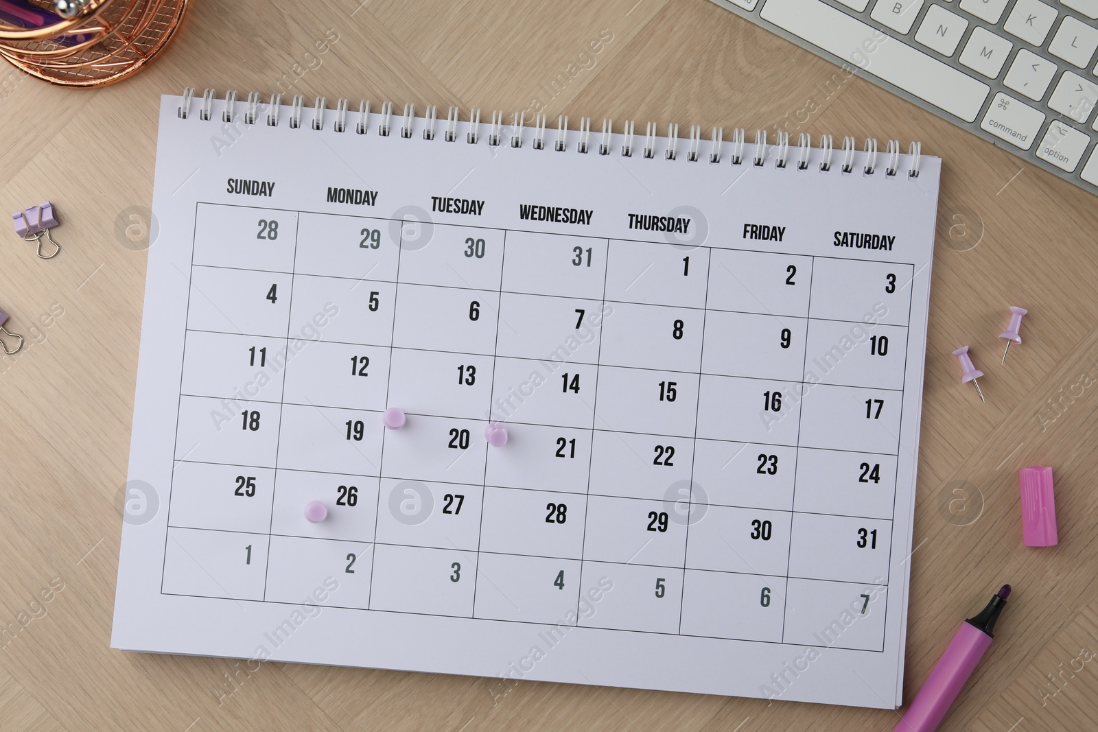 Photo of Timetable. Calendar, stationery and keyboard on wooden table, flat lay