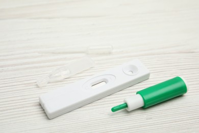 Photo of Disposable express test kit for hepatitis on white wooden table