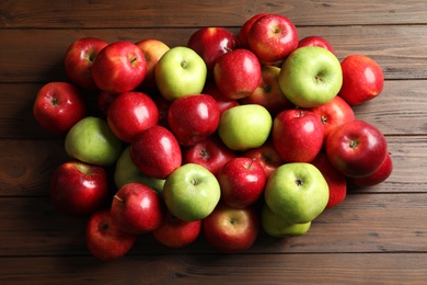 Photo of Fresh red and green apples on wooden background, top view