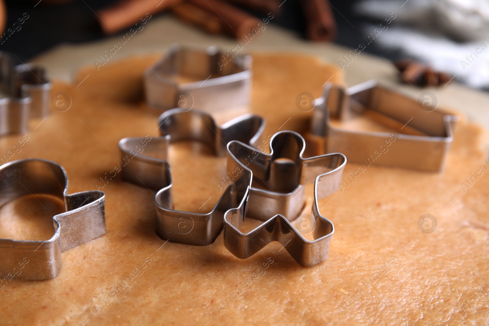 Photo of Making homemade Christmas cookies. Dough and cutters on table, closeup