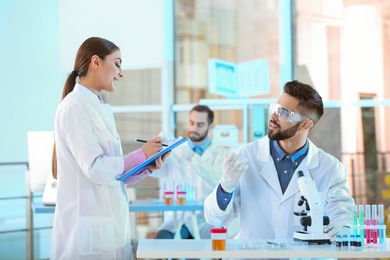 Young scientists working in laboratory. Chemical analysis