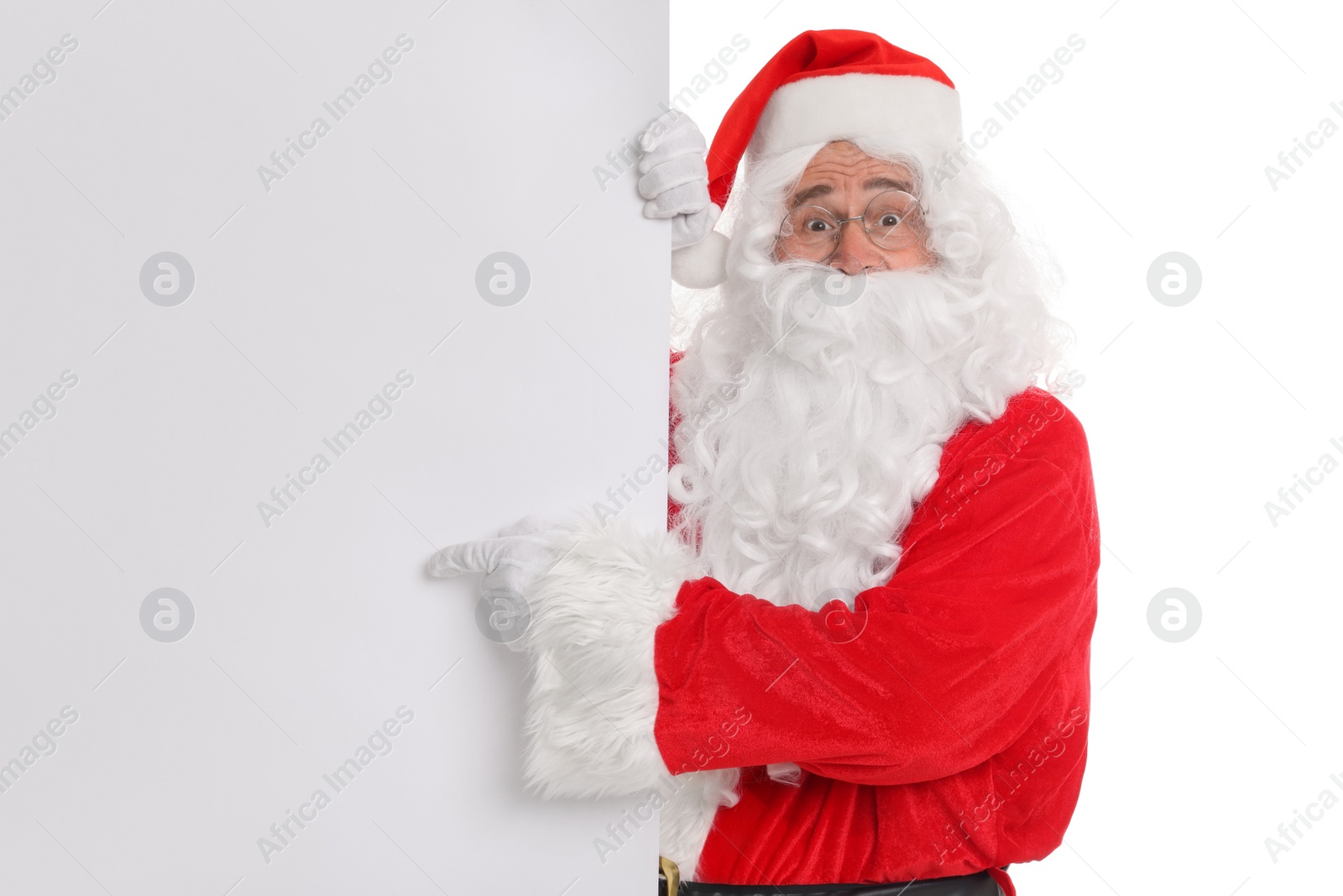 Photo of Man in Santa Claus costume posing and pointing on white background