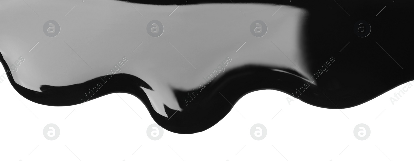 Photo of Black glossy paint spilled on white background, top view