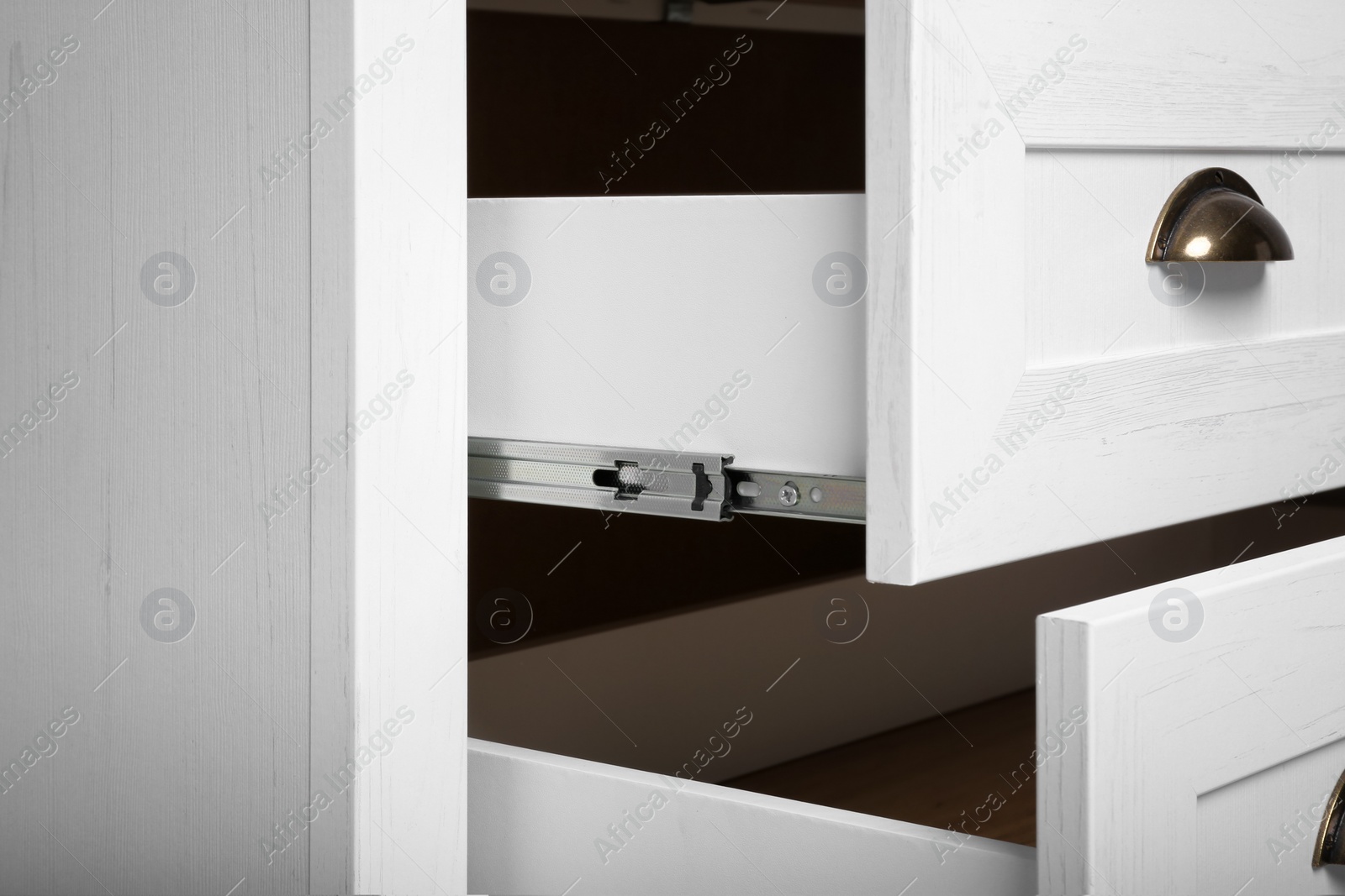 Photo of White chest of drawers, closeup. Furniture for wardrobe room