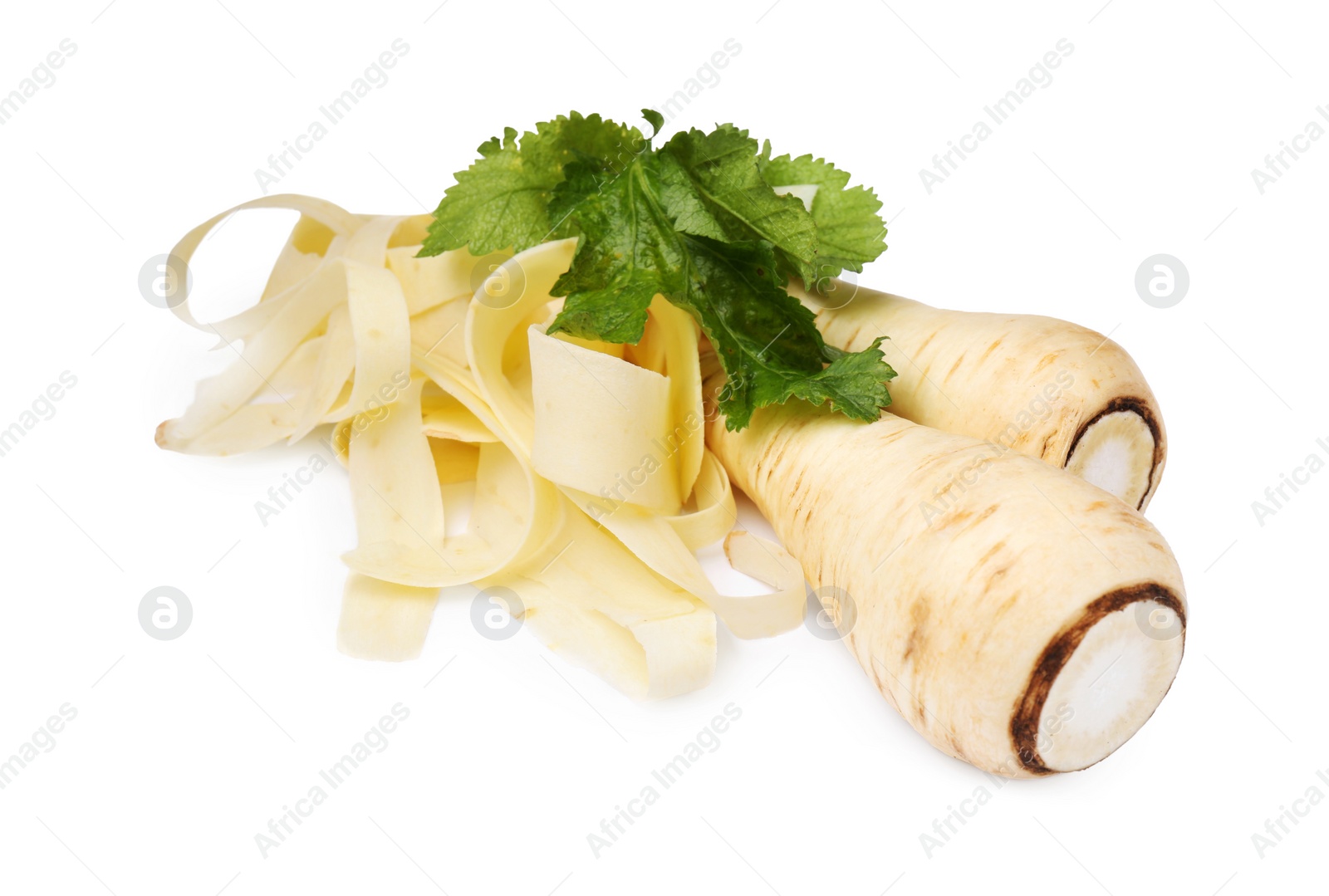 Photo of Whole and sliced fresh ripe parsnip with leaves on white background, closeup