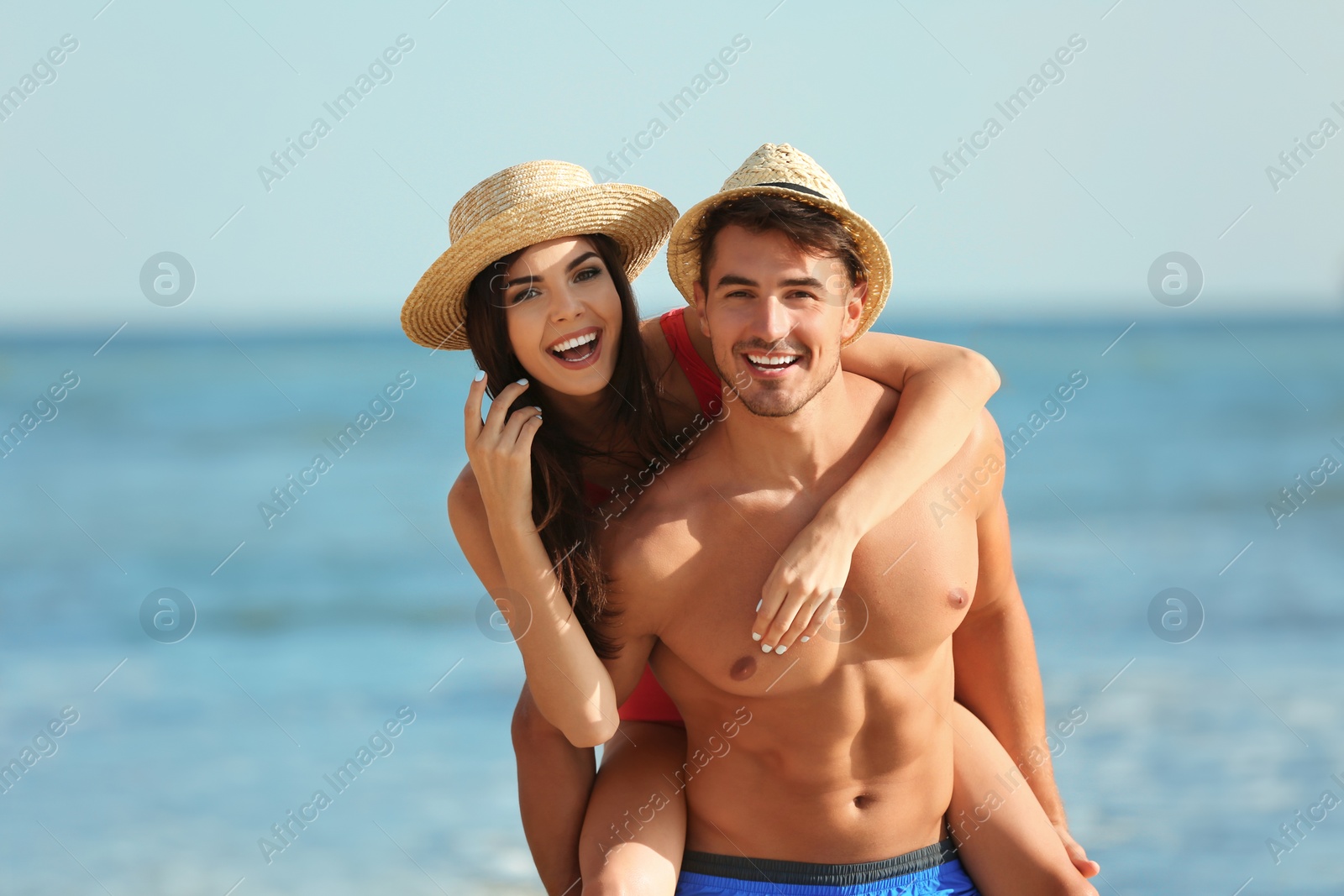 Photo of Happy young couple having fun at beach on sunny day