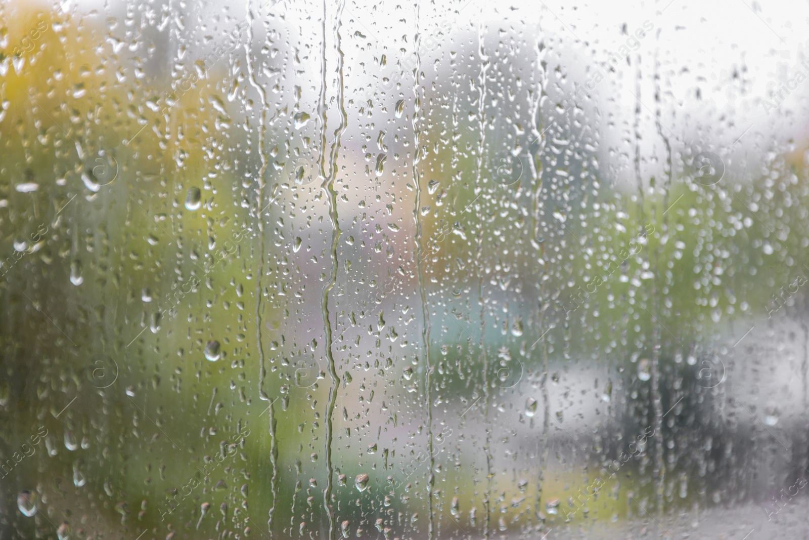 Photo of Window glass with water drops, closeup. Rainy weather