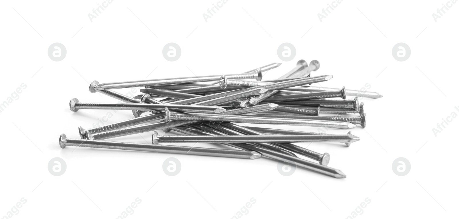 Photo of Pile of metal nails on white background