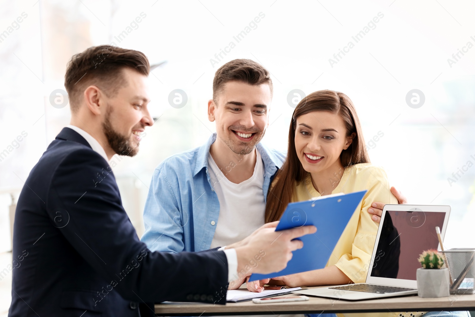 Photo of Young couple meeting with consultant in office