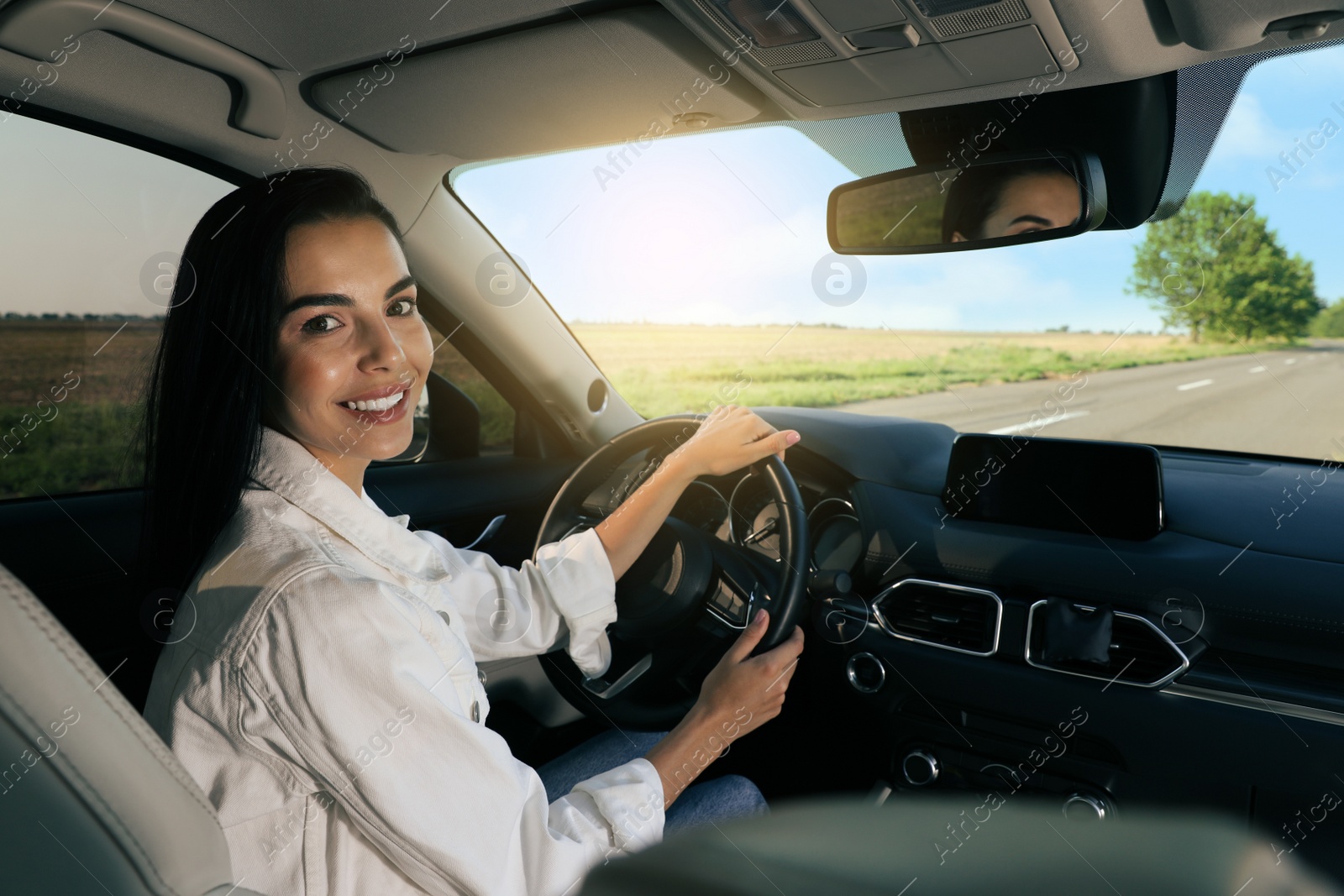 Photo of Beautiful young woman on driver's seat in modern car