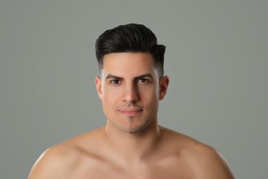 Photo of Handsome man with half shaved face on grey background