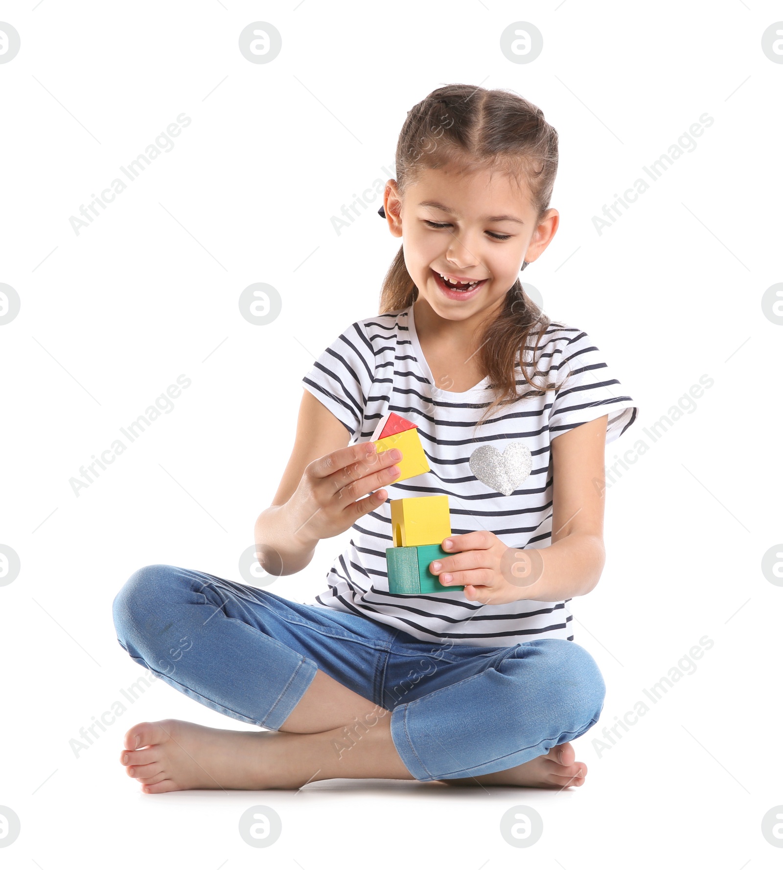 Photo of Cute child playing with colorful blocks on white background