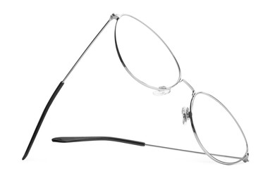 Photo of Stylish glasses with metal frame isolated on white