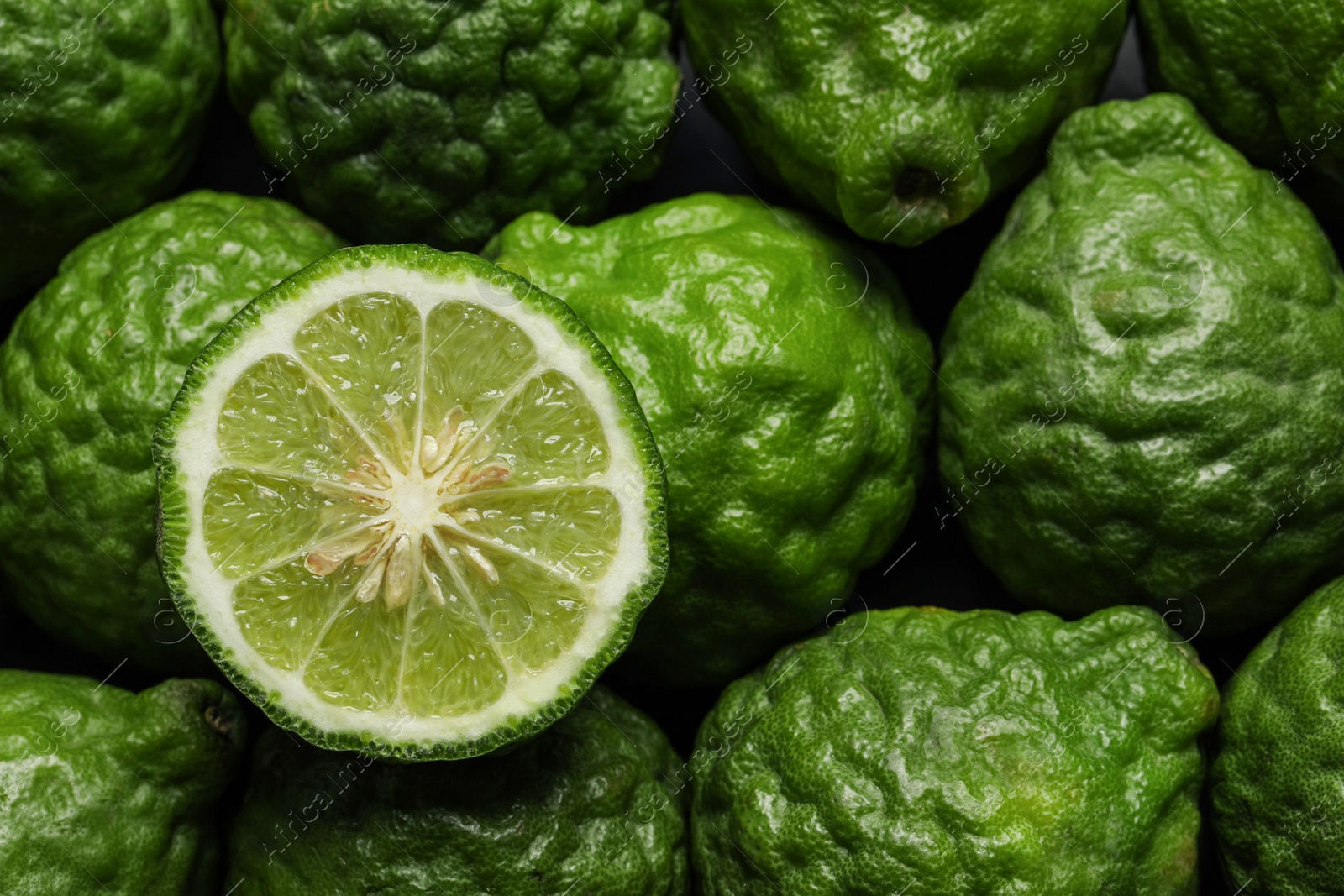 Photo of Whole and cut ripe bergamot fruits as background, top view